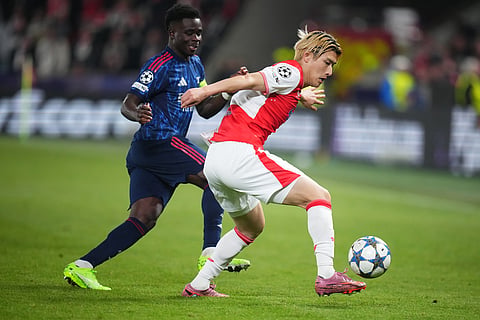 Slavia's Daiki Hashioka, right, is challenged by Arsenal's Bukayo Saka during the Champions League opening phase soccer match between Slavia Prague and Arsenal in Prague, Czech Republic.