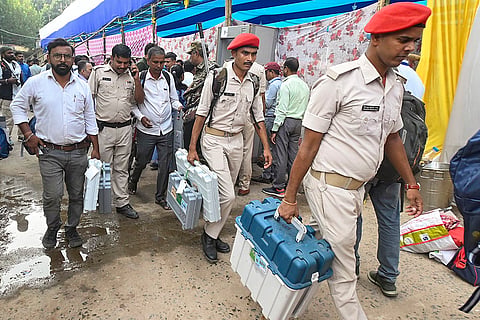 Security personnel with EVM and other election material leave for polling duty on the eve of the first phase of the Bihar Assembly elections, in Patna.