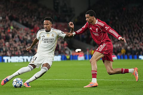 Real Madrid's Eder Militao, left, and Liverpool's Hugo Ekitike fight for the ball during the Champions League soccer match between Liverpool and Real Madrid in Liverpool, England.