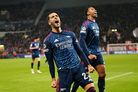 Arsenal's Mikel Merino, left, celebrates after scoring his side's third goal during the Champions League opening phase soccer match between Slavia Prague and Arsenal in Prague, Czech Republic.