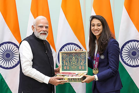 In this image, Prime Minister Narendra Modi with women's cricket team vice captain Smriti Mandhana during a meeting following the team's victory in the ODI World Cup, at his residence in New Delhi.