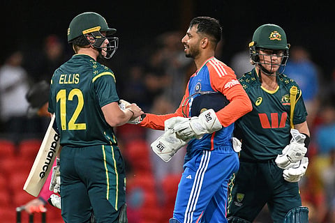 Jitesh Sharma of India is congratulated by Australia's Nathan Ellis, left, following a T20 cricket international between India and Australia in Carrara, Australia.
