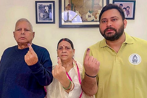 RJD chief Lalu Prasad Yadav, wife Rabri Devi, and son and party leader Tejashwi Yadav show their ink marked fingers after casting votes in the first phase of the Bihar Assembly elections, in Patna. 