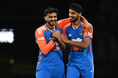 Indian bowler Arshdeep Singh, right, is congratulated by teammate Axar Patel after dismissing Australian batsman Josh Philippe during a T20 cricket international between India and Australia in Carrara, Australia.
