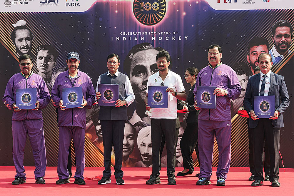 | Photo: PTI/Atul Yadav : Union Minister for Sports Mansukh Mandaviya with Tamil Nadu Deputy Chief Minister Udhayanidhi Stalin and others releases a book during the Hockey India centenary celebrations, at Major Dhyan Chand National Stadium, in New Delhi.