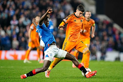 Rangers' Nasser Djiga, left, and Roma's Matias Soule in action during the Europa League soccer match between Rangers and Roma in Glasgow, Scotland.