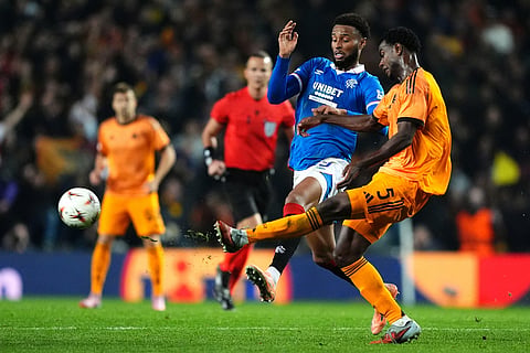 Rangers' Youssef Chermiti and Roma's Evan Ndicka, right, in action during the Europa League soccer match between Rangers and Roma in Glasgow, Scotland.