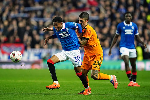 Rangers' Jayden Meghoma, left, and Roma's Gianluca Mancini in action during the Europa League soccer match between Rangers and Roma in Glasgow, Scotland.