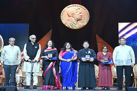 In this photo provided by the Ramon Magsaysay Awards Foundation, Ujwal Thakar, second from left, Safeena Husain, Safeena Husain, 3rd from left, and Gayatri Nair Lobo, center, from the Foundation to Educate Girls Globally based in India, receive the 67th Ramon Magsaysay Award along with fellow awardees Filipino Catholic priest Flaviano Villanueva, 3rd from right, and Maldivian marine ecosystem conservationist Shaahina Ali, 2nd from right, during ceremonies in Manila, Philippines. Standing with them is Edgar O. Chua, left, RMAF Chairperson and Francisco Magsaysay, right, grandson of the late Pres. Ramon Magsaysay.