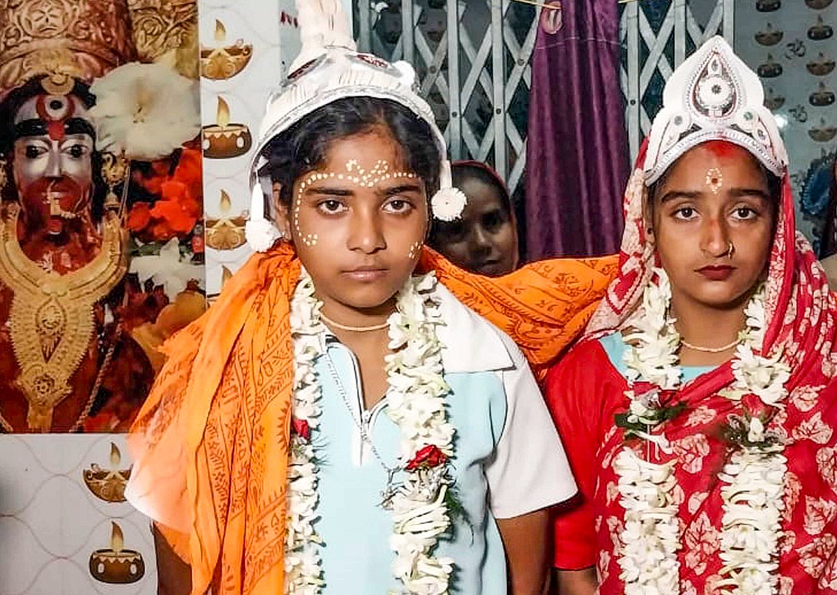 PTI : The 'wedding' of same-sex couple Riya Sardar and Rakhi Naskar being solemnised by the residents of Kultali village in West Bengal's Sundarbans. 