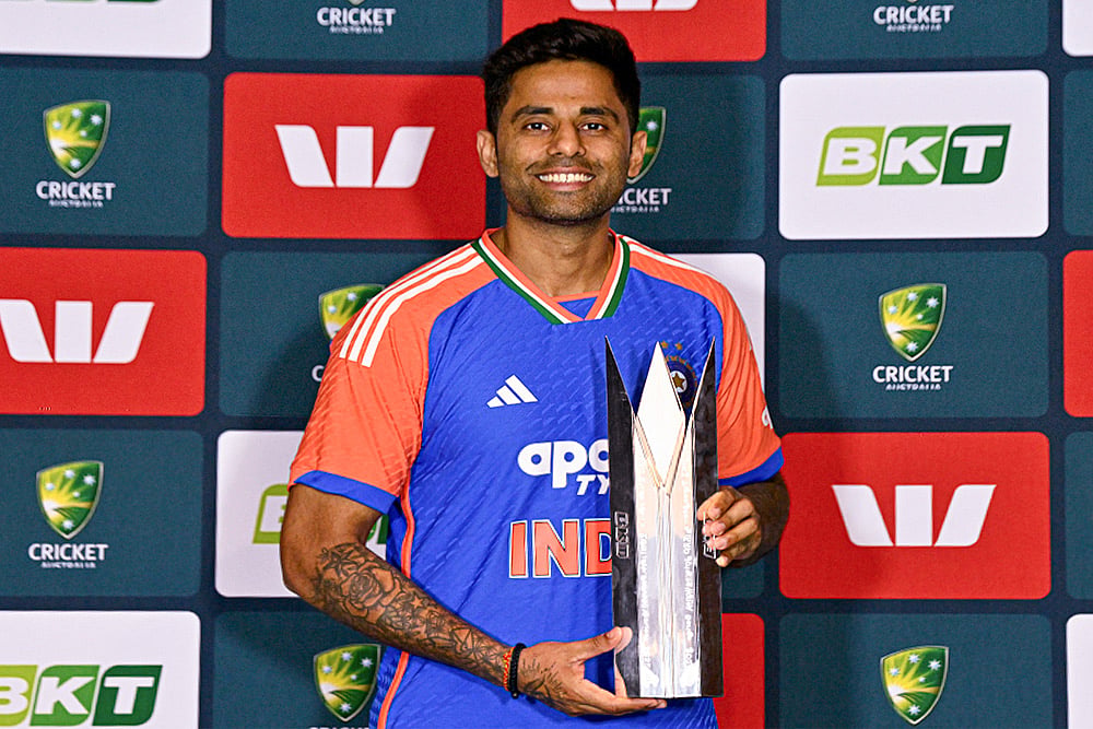 | Photo: PTI/Izhar Khan : India's captain Suryakumar Yadav poses with the series trophy at the end of the five match T20I cricket series between India and Australia, in Brisbane, Australia. The fifth match got abandoned due to rain and India won the series 2-1. 