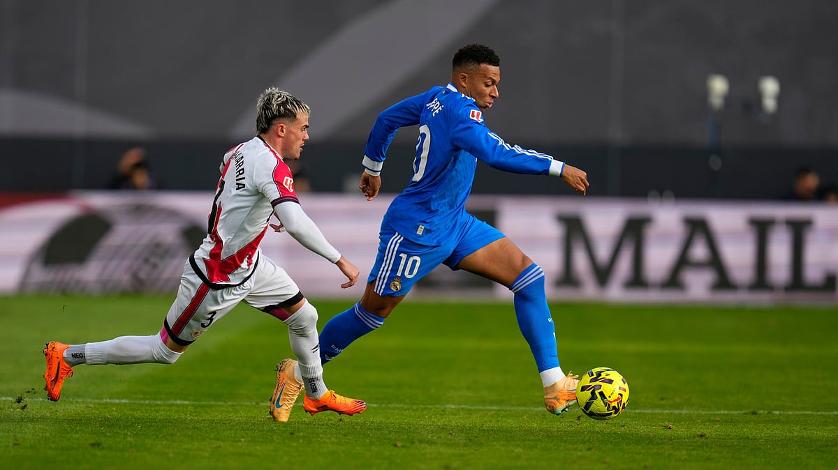 (AP Photo/Manu Fernandez) : Real Madrid's Kylian Mbappe runs ahead with the ball during a Spanish La Liga soccer match between Rayo Vallecano and Real Madrid in Madrid, Spain, Sunday, Nov. 9, 2025.