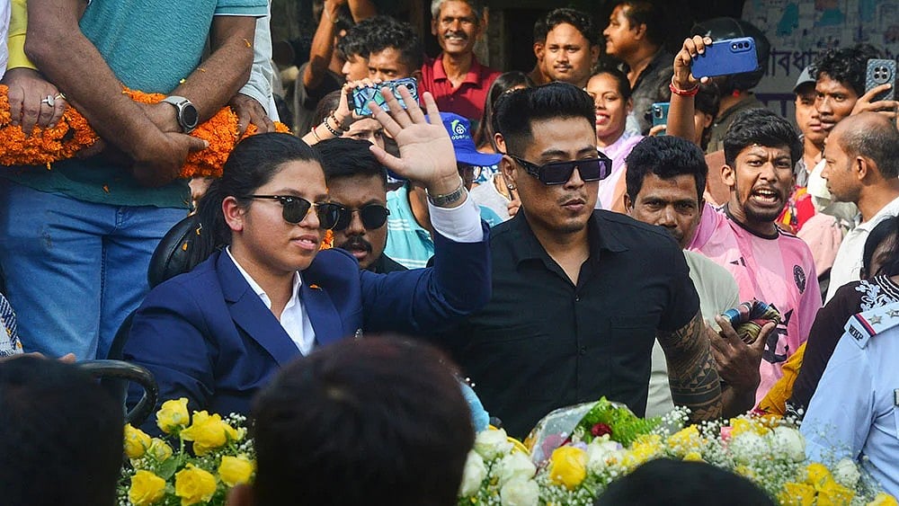 | Photo: PTI : Richa Ghosh, member of the Women's ODI World Cup 2025-winning Indian cricket team, arrives in her hometown, Siliguri, West Bengal.