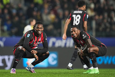 AC Milan's Rafael Leao, left, celebrates with teammate Pervis Estupinan after scoring during the Serie A soccer match between Parma and Milan in Parma, Italy.