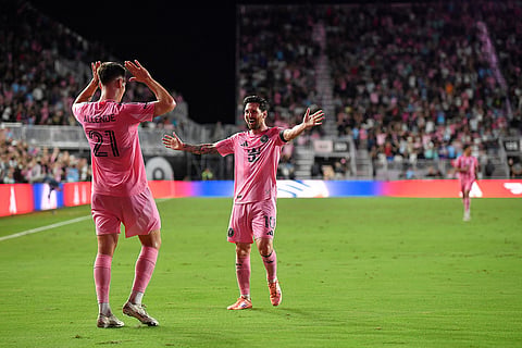 Inter Miami forward Tadeo Allende (21) celebrates with Lionel Messi (10) after a goal during the second half of Game 3 in the first round of MLS soccer's Western Conference playoffs against Nashville SC in Fort Lauderdale, Florida.