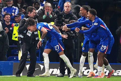 Chelsea's Malo Gusto, left, celebrates with teammates after scoring his team's first goal during the English Premier League soccer match against the Wolverhampton Wanderers in London.