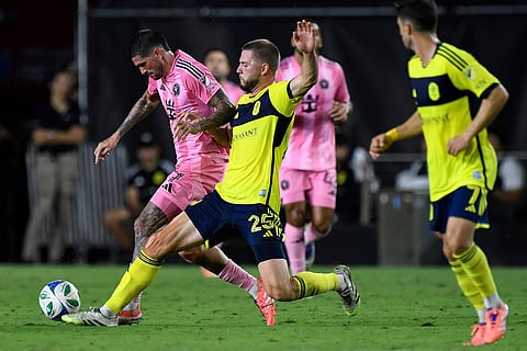 Nashville SC defender Walker Zimmerman (25) tries to steal the ball from Inter Miami midfielder Rodrigo de Paul, left, during the second half of Game 3 in the first round of MLS soccer's Western Conference playoffs in Fort Lauderdale, Florida.