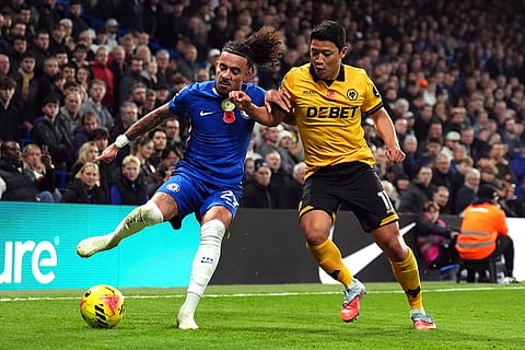 Chelsea's Malo Gusto (left) and Wolverhampton Wanderers' Hwang Hee-Chan battle for the ball during the English Premier League soccer match between Chelsea and Wolverhampton Wanderers in London.