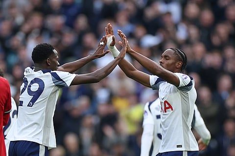 Tottenham's Mathys Tel, right, celebrates with Tottenham's Pape Matar Sarr after scoring his side's opening goal during the English Premier League soccer match between Tottenham Hotspur and Manchester United in London, England.