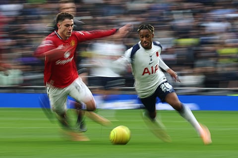 Manchester United's Manuel Ugarte, left, challenges for the ball with Tottenham's Wilson Odobert during the English Premier League soccer match between Tottenham Hotspur and Manchester United in London, England.