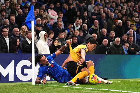 Chelsea's Malo Gusto (left) and Wolverhampton Wanderers' Hwang Hee-Chan battle for the ball during the English Premier League soccer match between Chelsea and Wolverhampton Wanderers in London.