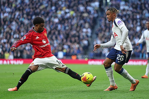 Manchester United's Amad Diallo, left, challenges for the ball with Tottenham's Wilson Odobert during the English Premier League soccer match between Tottenham Hotspur and Manchester United in London, England.