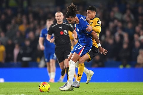 Chelsea's Malo Gusto (left) and Wolverhampton Wanderers' Joao Gomes battle for the ball during the English Premier League soccer match between Chelsea and Wolverhampton Wanderers in London.
