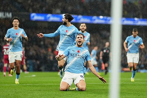 Manchester City's Nico Gonzalez, centre, celebrates after scoring his side's second goal during the English Premier League soccer match between Manchester City and Liverpool in Manchester, England.