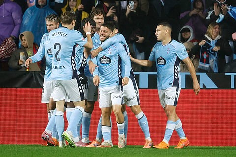 Celta's Sergio Carreira, center, is congratulated after scoring his side's first goal during the Spanish La Liga soccer match between Celta Vigo and Barcelona in Vigo, Spain.