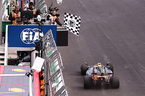 The checkered flag is waved as McLaren driver Lando Norris of Britain crosses the finish line to win the Brazilian Formula One Grand Prix at the Interlagos race track in Sao Paulo.
