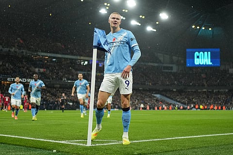 Manchester City's Erling Haaland celebrates after scoring his side's opening goal during the English Premier League soccer match between Manchester City and Liverpool in Manchester, England.