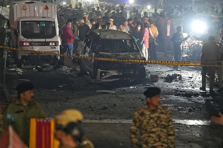 Police, security and rescue personnel at the site after a blast in a parked car near Red Fort left multiple vehicles in flames, in New Delhi. - | Photo: Suresh K. Pandey/Outlook