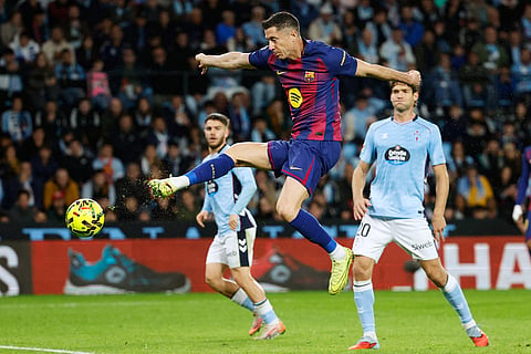 Barcelona's Robert Lewandowski scores his side's 2nd goal during the Spanish La Liga soccer match between Celta Vigo and Barcelona in Vigo, Spain.