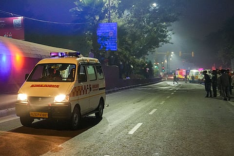 An ambulance leaves from the spot after a blast occurred in a parked car near Red Fort, leaving multiple vehicles in flames, in New Delhi. At least eight people were killed and 24 others suffered injuries in the incident.