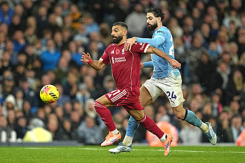 Liverpool's Mohamed Salah, left, challenges for the ball with Manchester City's Josko Gvardiol during the English Premier League soccer match between Manchester City and Liverpool in Manchester, England.