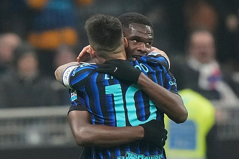 Inter Milan's Ange-Yoan Bonny, rear, celebrates after scoring his side's second goal during a Serie A soccer match between Inter Milan and Lazio, in Milan, Italy.