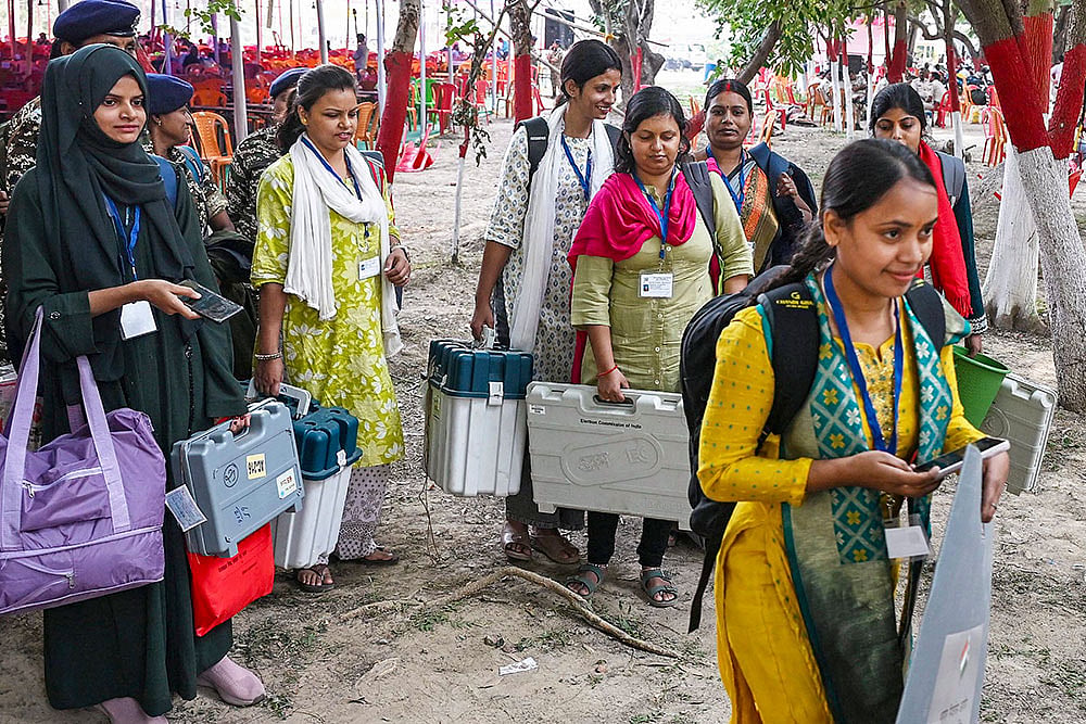 | Photo: PTI : Polling officials carrying election material leave for their respective polling booths, a day before the second and final phase of Bihar Assembly elections, in Jehanabad.