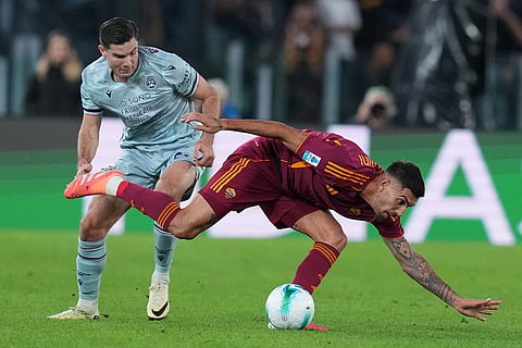 Roma's Lorenzo Pellegrini, right, goes for the ball during the Serie A soccer match between Roma and Udinese, in Rome.