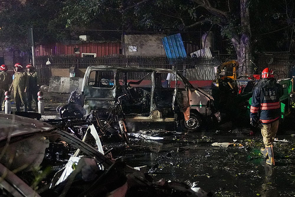 Firefighters at the spot after a blast occurred in a parked car near Red Fort, leaving multiple vehicles in flames, in New Delhi. - | Photo: PTI/Salman Ali