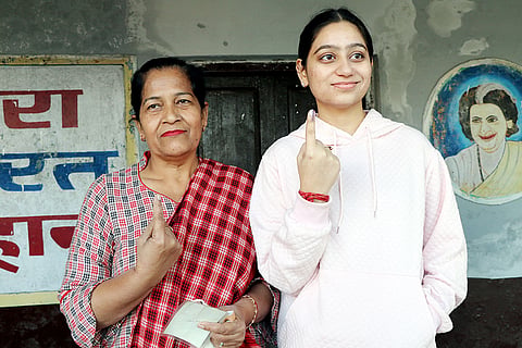 Voters show their ink-marked fingers after casting votes during the Nagrota Assembly bypoll, in Jammu district.