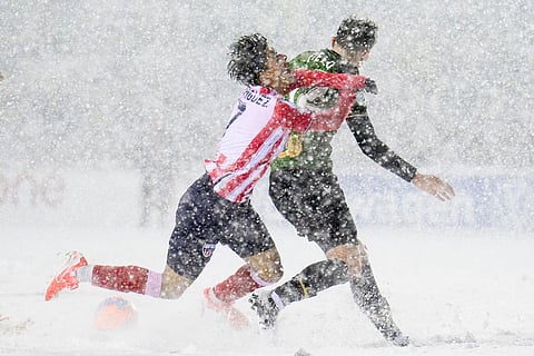 Atletico Ottawa's David Rodríguez, left, loses his footing as he crashes into Atletico Ottawa's Monty Patterson, right, during second-half Canadian Premier League finals soccer match action in Ottawa, Ontario.