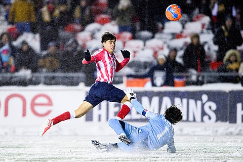 Atletico Ottawa's David Rodríguez (7) scores on Cavalry FC's Ali Musse (7) during extra time Canadian Premier League finals soccer action in Ottawa.