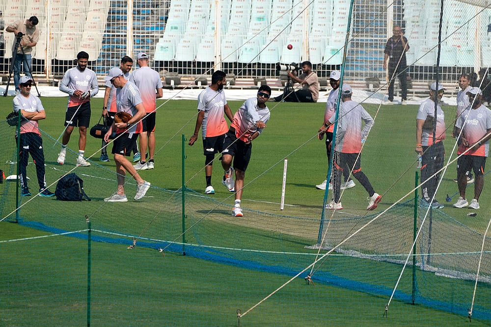 Washington Sunder bowls at net as chief coach Gautam Gambhir, left, looks on during a practice session ahead of the first test match between India and South Africa, in Kolkata. - Photo: AP/Bikas Das