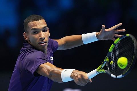Canada's Felix Auger-Aliassime returns the ball to Italy's Jannik Sinner during their tennis match of the ATP World Tour Finals, in Turin, Italy.