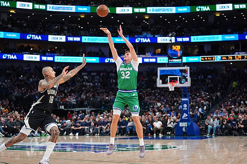 Dallas Mavericks forward Cooper Flagg (32) shoots against Milwaukee Bucks forward Kyle Kuzma (18) during the second half of an NBA basketball game in Dallas.
