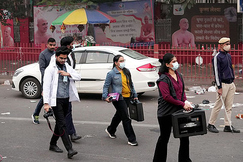 Forensic officials at the site in the aftermath of the blast that occurred near Red Fort Metro Station on Monday, killing at least nine people and gutting several vehicles, in New Delhi.