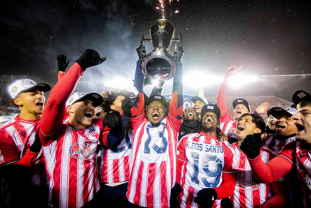 | Photo: Spencer Colby/The Canadian Press via AP : Atletico Ottawa's Ballou Tabla (13) raises the North Star Cup following Atletico Ottawa's victory over Cavalry FC in extra time during the Canadian Premier League finals soccer action in Ottawa.