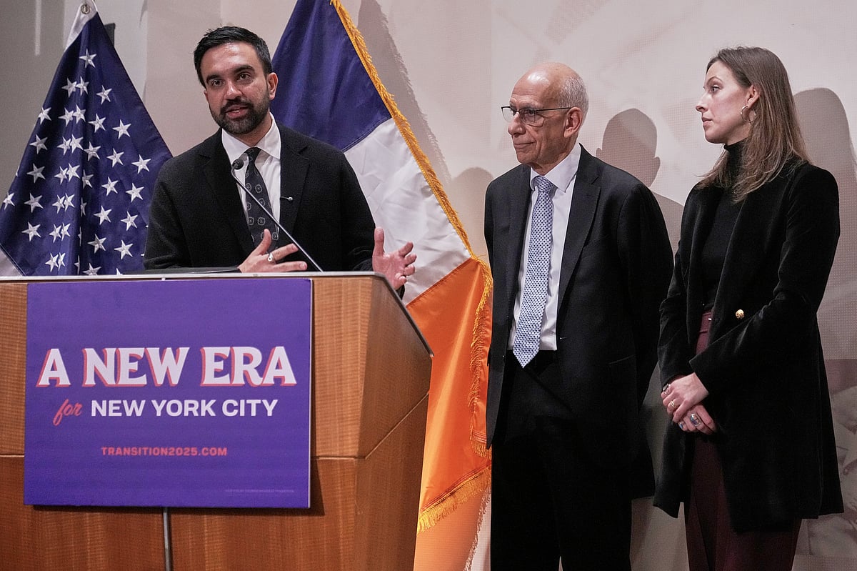 Richard Drew/AP : New York Mayor-elect Zohran Mamdani, left, announces the appointment of Dean Fuleihan, center, as first deputy mayor and Elle Bisgaard-Church as chief of staff, in New York, Monday, Nov. 10, 2025.