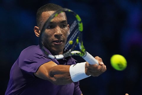 Canada's Felix Auger-Aliassime returns the ball to Italy's Jannik Sinner during their tennis match of the ATP World Tour Finals, in Turin, Italy.