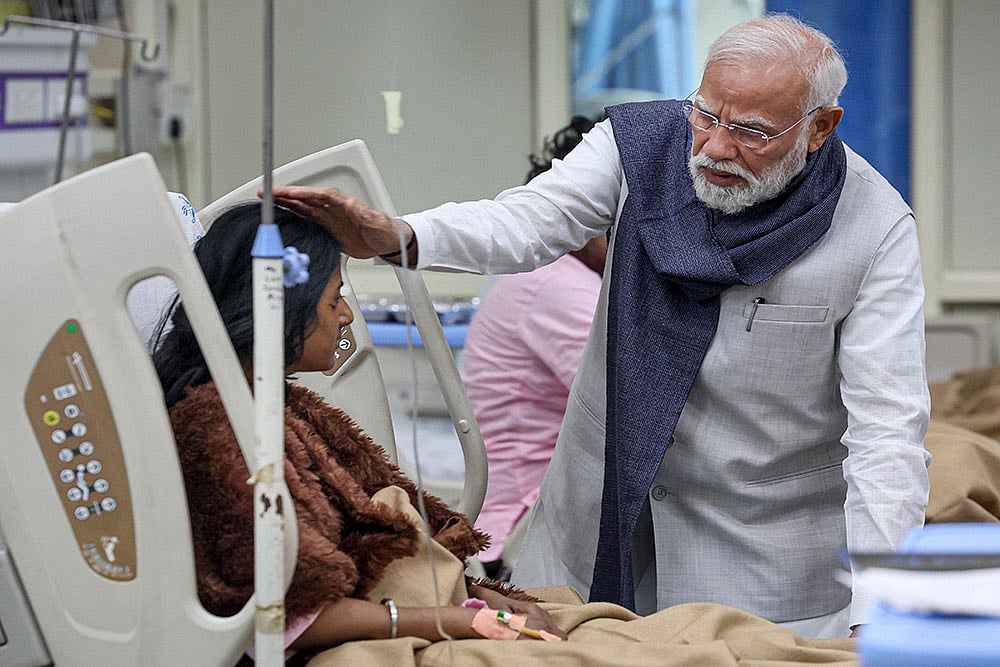 | Photo: PMO via PTI : In this image, Prime Minister Narendra Modi meets an injured victim undergoing treatment at LNJP hospital following a blast near the Red Fort, in New Delhi.